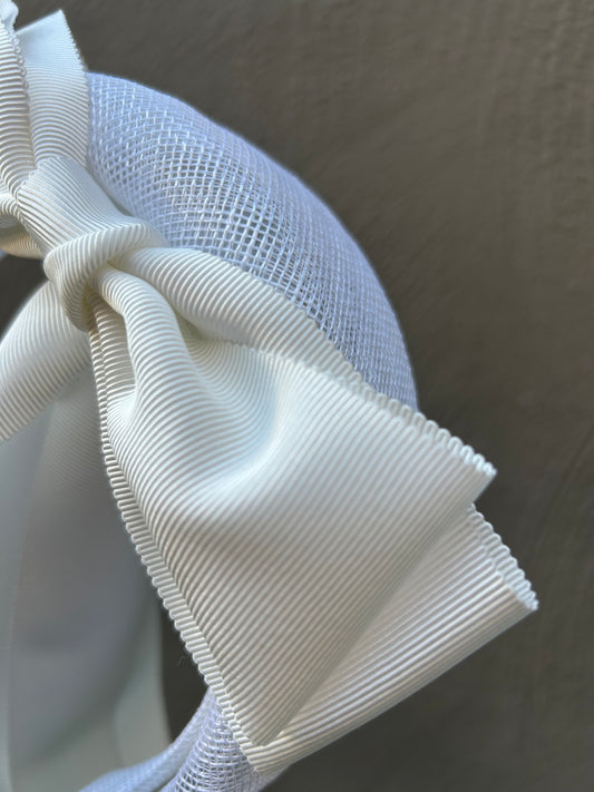 white headpiece with white ribbon bows