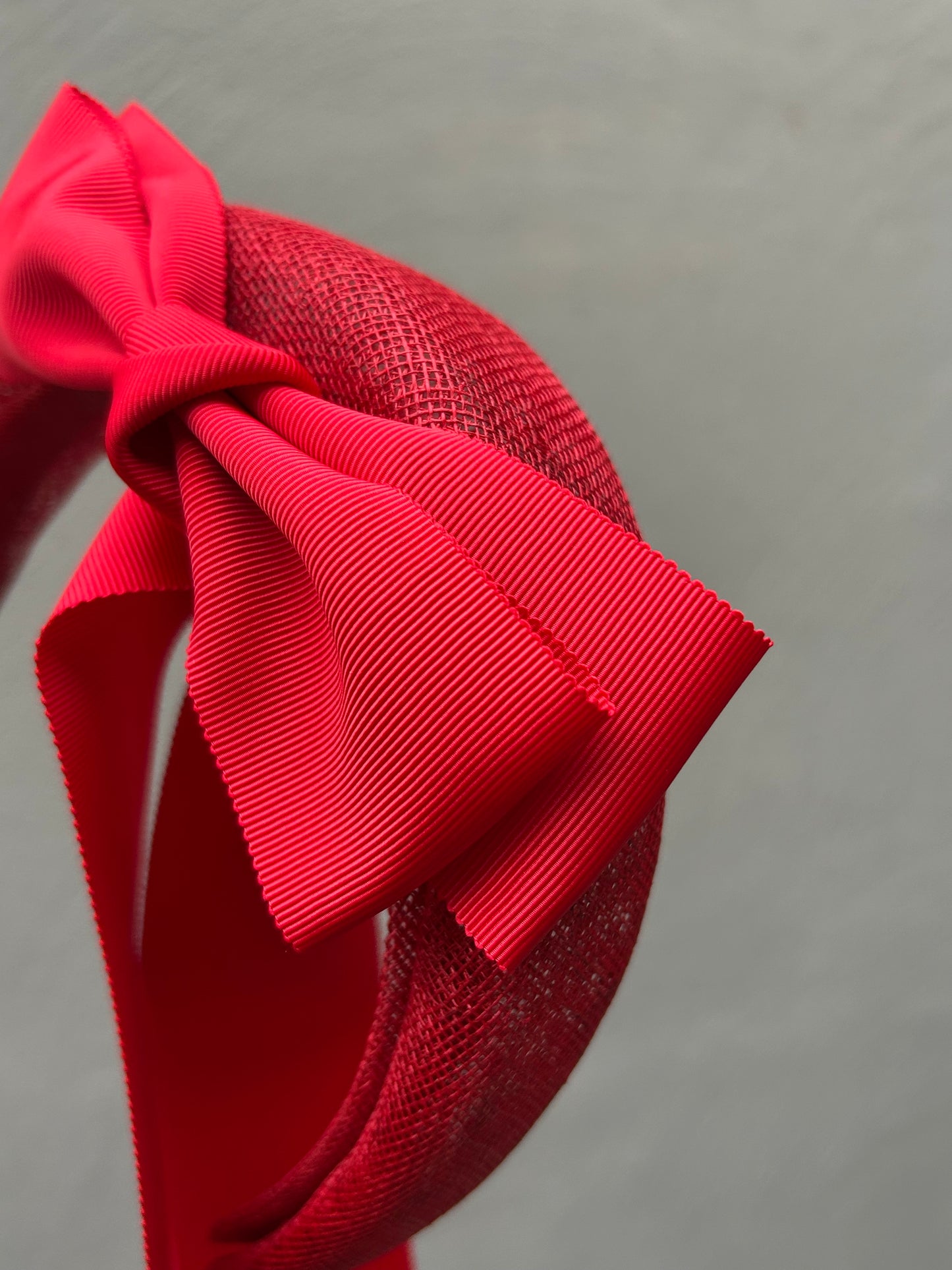 Handcrafted red bow headband for Melbourne Cup race day fashion.