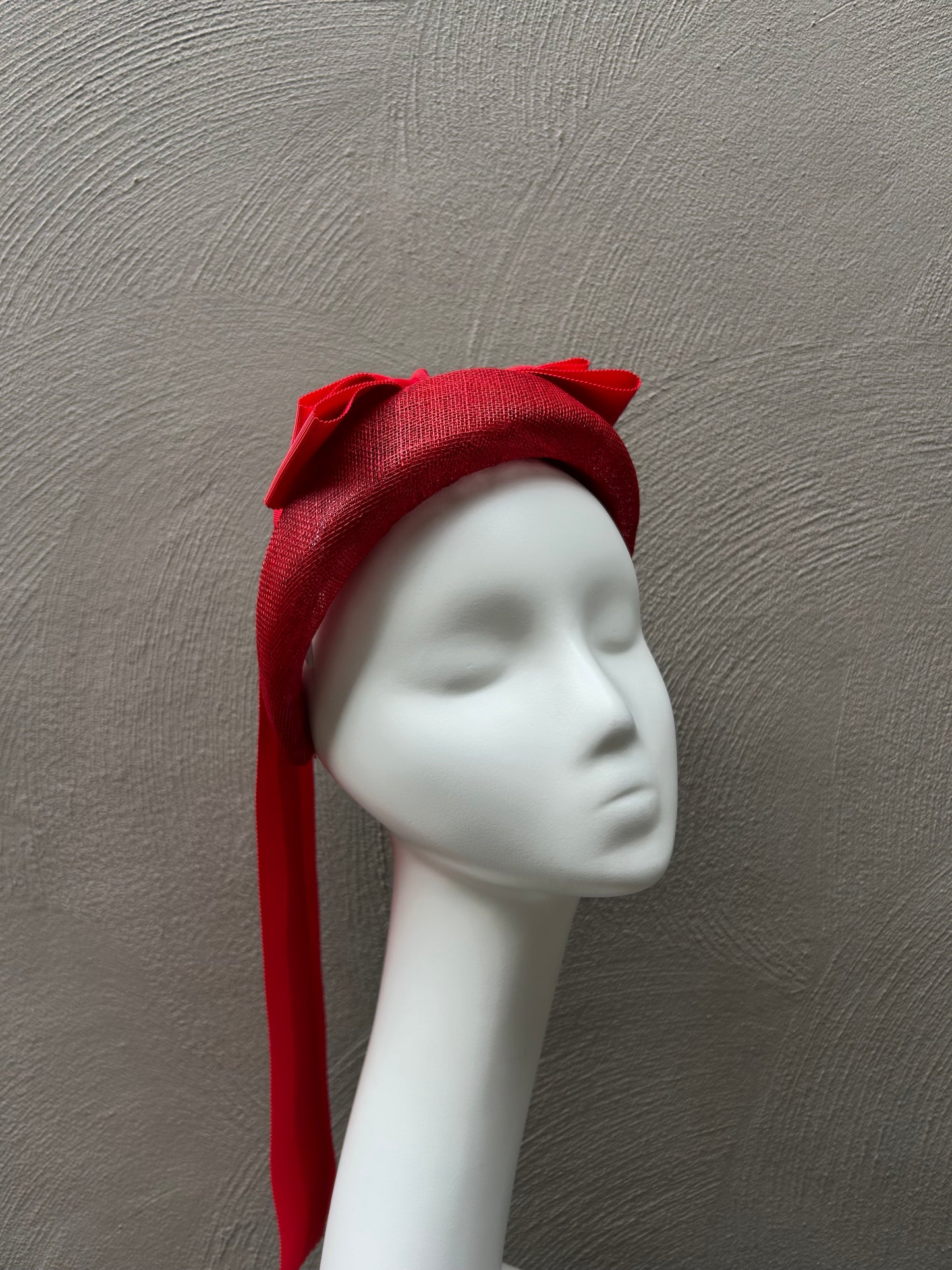 Handcrafted red bow headband for Melbourne Cup race day fashion.