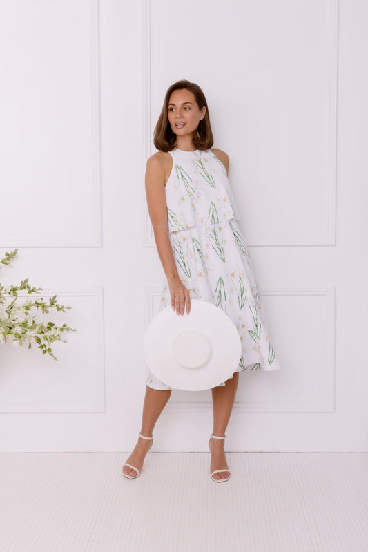 White dress with lily print and white straw boater hat