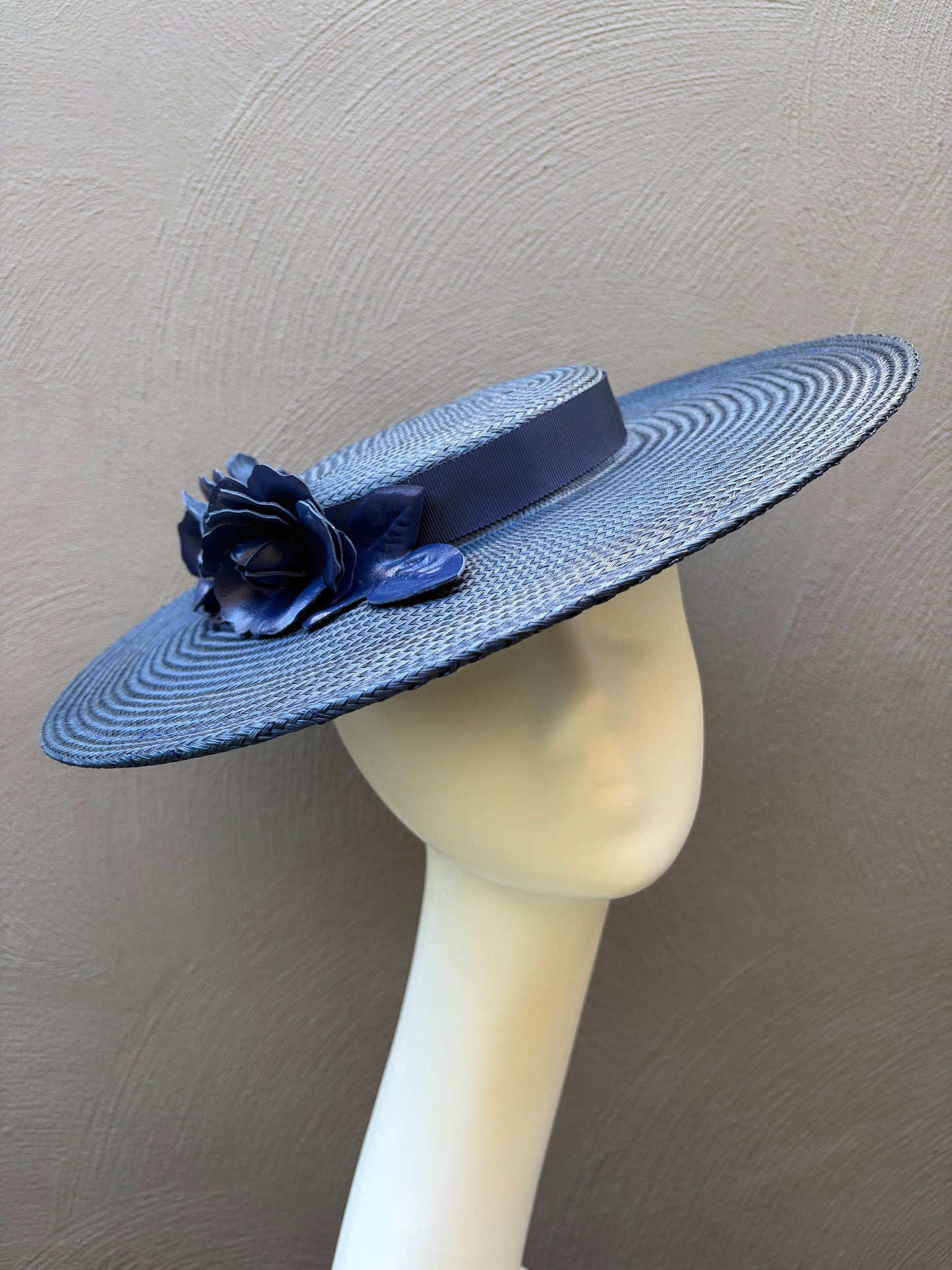 Wide‑brim navy blue straw boater hat with handcrafted leather roses.