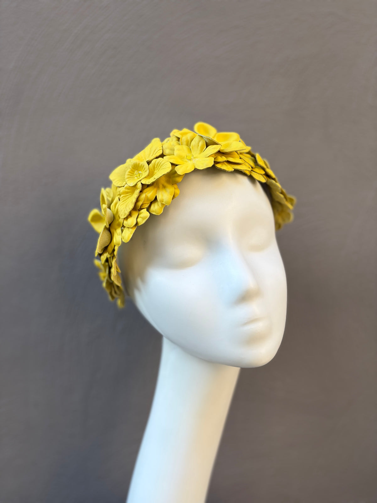 Sunshine yellow leather floral headpiece featuring handcrafted leather flowers with crystal centres, designed for racewear and special occasions.