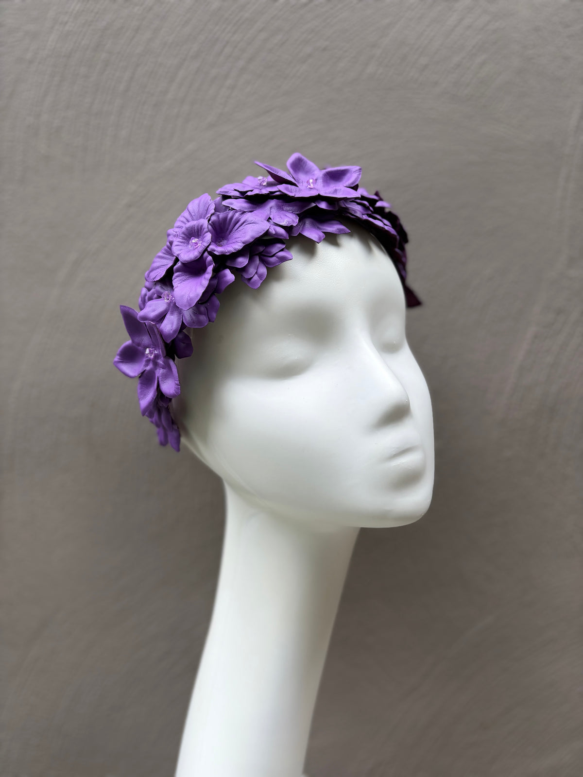 Luxury violet leather floral headpiece featuring handcrafted flowers and crystal centres.